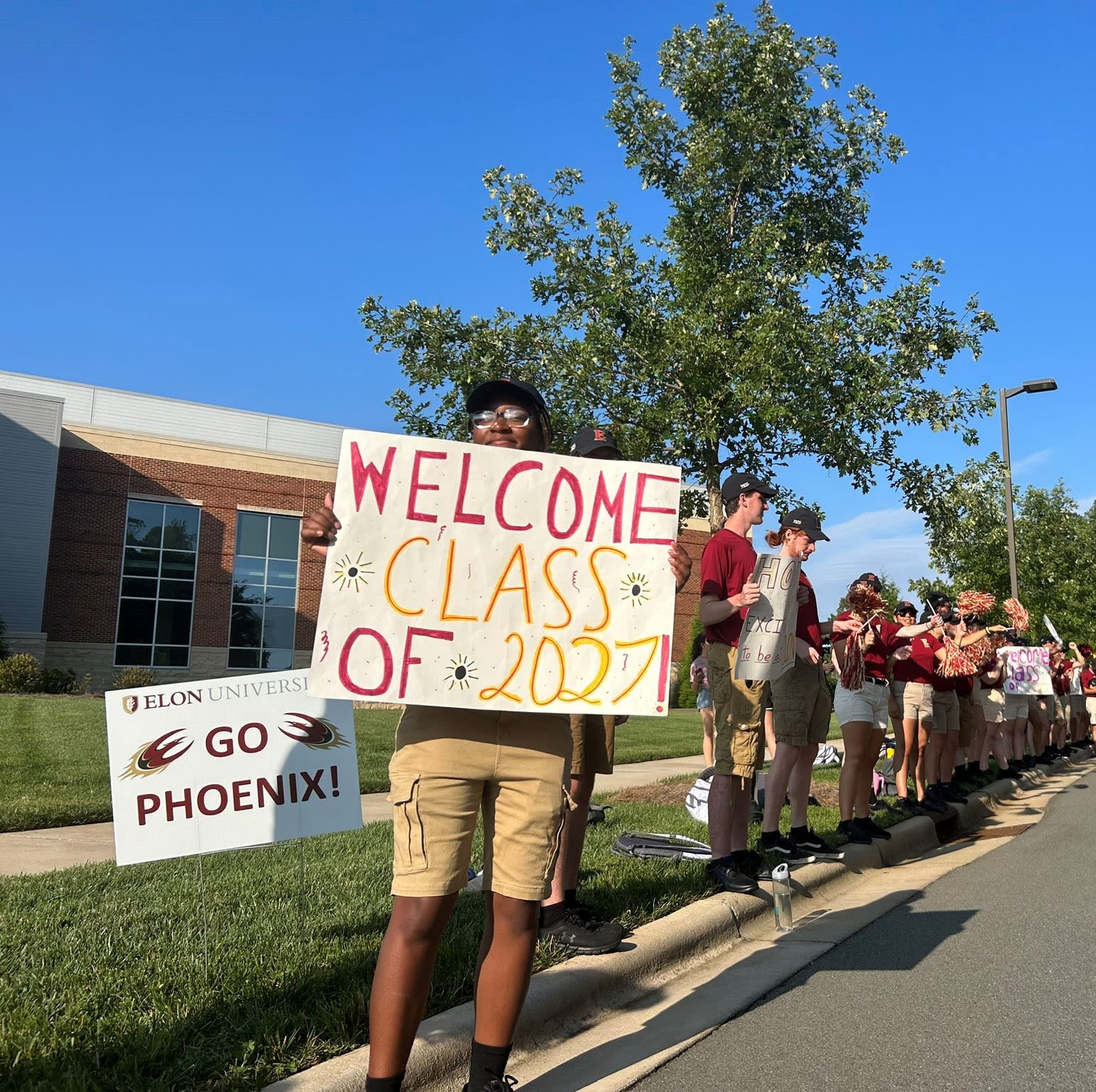 Members of the Fire of the Carolinas welcome the class of 2027 with spirit as they cheer and celebrate as students pull in for check-in at the Schar Center on Aug. 18. Photo by: Abby Hobbs